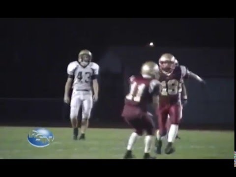 High school football image. Three football players on a football field.