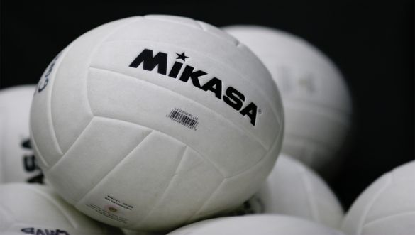 A pile of volleyballs with the word "mikasa" on it.